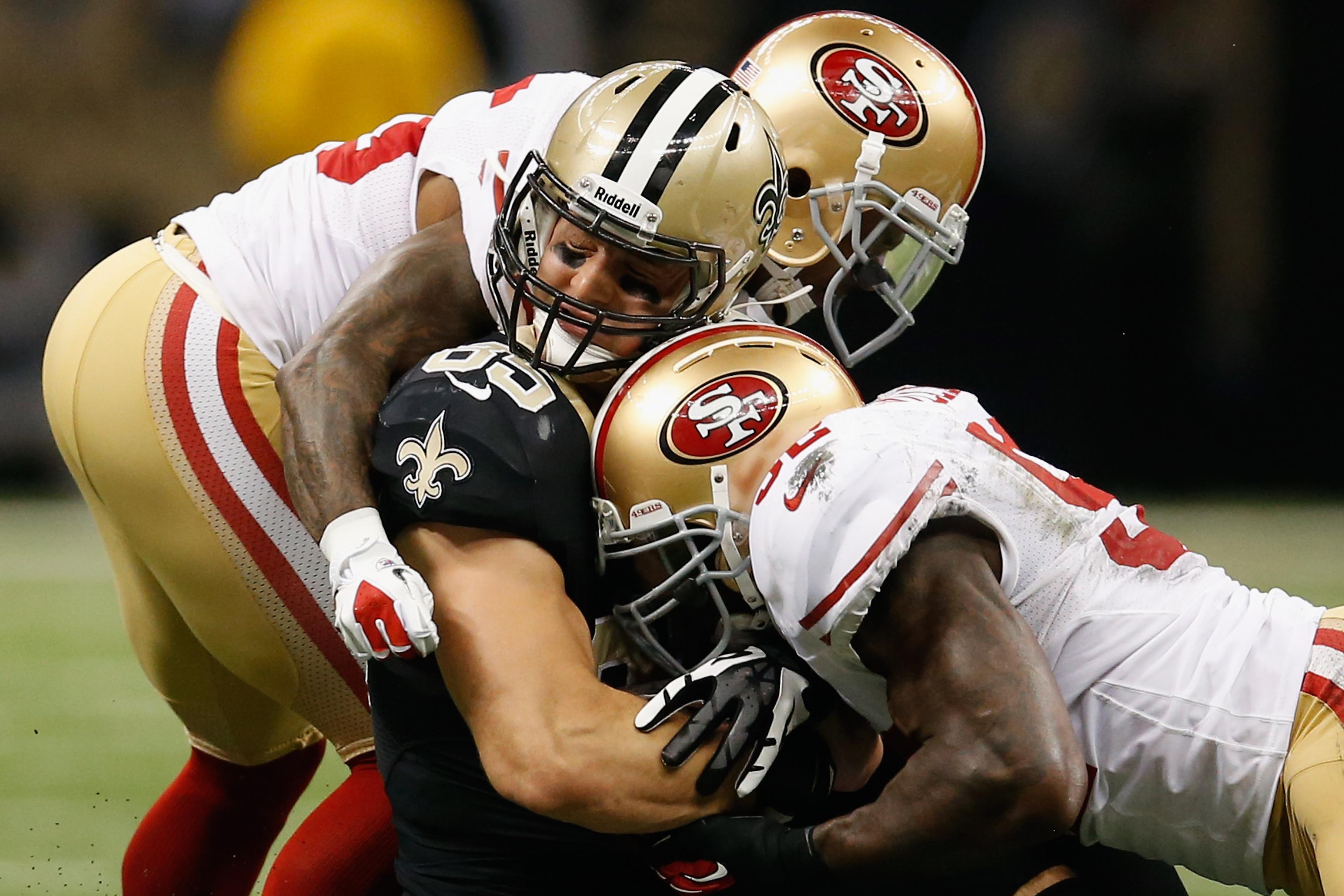 Justin Smith and Dashon Goldson of the San Francisco 49ers tackle