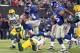 November 25, 2012; East Rutherford, NJ, USA; New York Giants running back Ahmad Bradshaw (44) leaps over Green Bay Packers linebacker A.J. Hawk (50) en route to a touchdown during the second quarter of an NFL game at MetLife Stadium. Mandatory Credit: Brad Penner-US PRESSWIRE