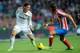 MADRID, SPAIN - NOVEMBER 26: Mesut Ozil (L) of Real Madrid takes on Felipe Luis of Atletico Madrid during the La Liga match between Real Madrid and Atletico Madrid at Estadio Santiago Bernabeu on November 26, 2011 in Madrid, Spain. (Photo by Denis Doyle/Getty Images)