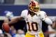ARLINGTON, TX - NOVEMBER 22: Robert Griffin III #10 of the Washington Redskins scrambles with the ball before being sacked by Jason Hatcher #97 of the Dallas Cowboys on Thanksgiving Day at Cowboys Stadium on November 22, 2012 in Arlington, Texas. (Photo by Tom Pennington/Getty Images)