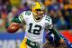 EAST RUTHERFORD, NJ - NOVEMBER 25: quarterback Aaron Rodgers #12 of the Green Bay Packers scrambles with the ball against defensive end Justin Tuck #91 of the New York Giants at MetLife Stadium on November 25, 2012 in East Rutherford, New Jersey. (Photo by Rich Schultz/Getty Images)