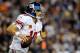 LANDOVER, MD - DECEMBER 03: Quarterback Eli Manning #10 of the New York Giants runs five-yards for a first down in the third quarter against the Washington Redskins at FedExField on December 3, 2012 in Landover, Maryland. (Photo by Patrick McDermott/Getty Images)