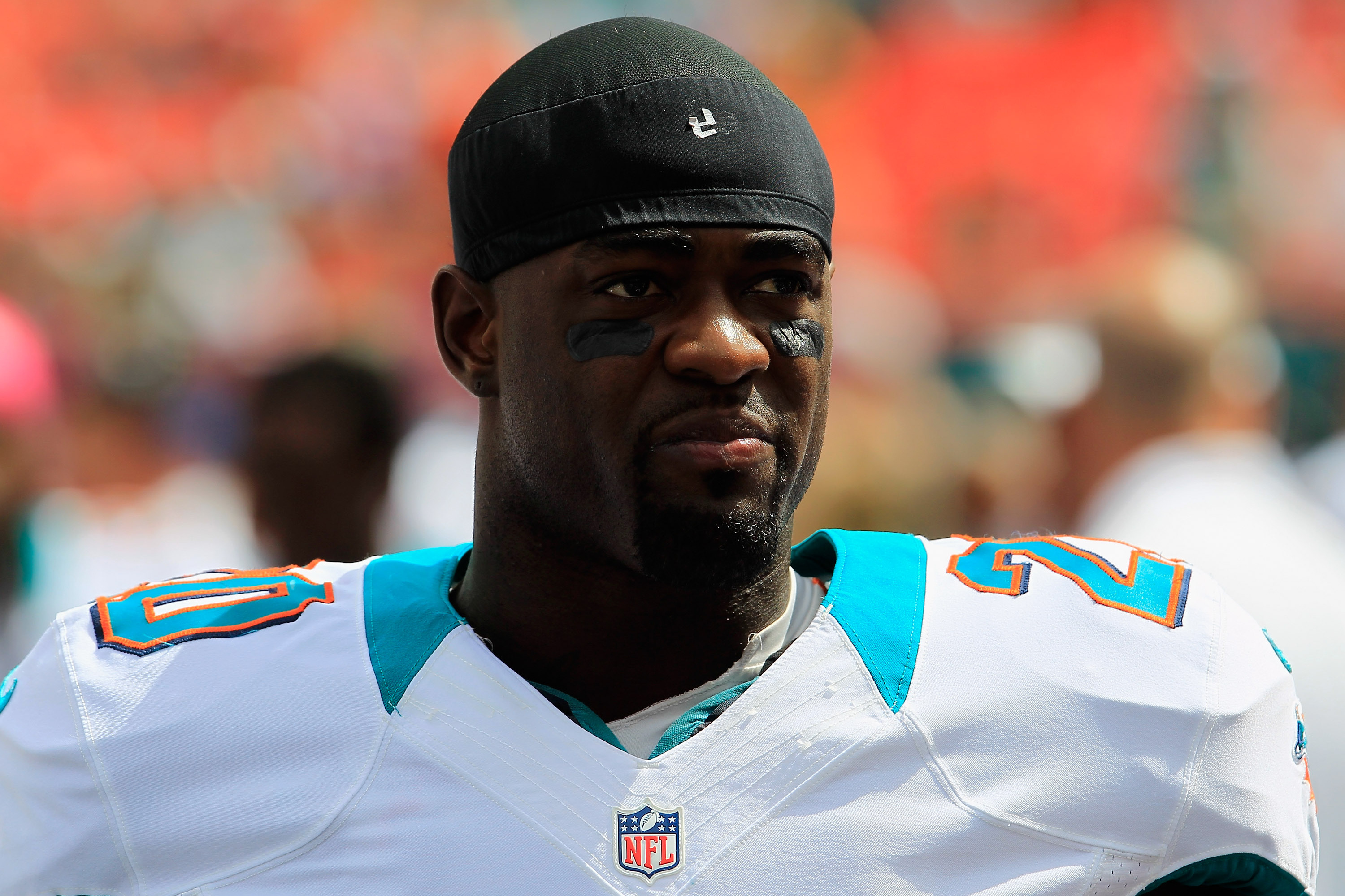 Miami Dolphins free safety Reshad Jones, right, signs autographs after the  teams NFL football t …