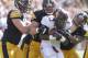 IOWA CITY, IA- SEPTEMBER 29: Defensive linemen Joe Gaglione #99, Louis Trinca-Pasat #90 and linebacker Anthony Hitchens #31 of the Iowa Hawkeyes make a tackle during the fourth quarter of running back Donnell Kirkwood #20 of the Minnesota Gophers on September 29, 2012 at Kinnick Stadium in Iowa City, Iowa. Iowa defeated Minnesota 31-13. (Photo by Matthew Holst/Getty Images)
