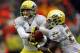 CORVALLIS, OR - NOVEMBER 24: Marcus Mariota #8 of the Oregon Duckshands off the ball to Kenjon Barner #24 against the Oregon State Beavers during the 116th Civil War on November 24, 2012 at the Reser Stadium in Corvallis, Oregon. (Photo by Jonathan Ferrey/Getty Images)