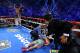 Manny Pacquiao receives medical treatment while Juan Manuel Marquez celebrates his victory.