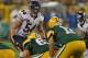 GREEN BAY, WI - SEPTEMBER 13: Brian Urlacher #54 of the Chicago Bears watches as Aaron Rodgers #12 of the Green Bay Packers calls the signals at Lambeau Field on September 13, 2012 in Green Bay, Wisconsin. The Packers defeated the Bears 23-10. (Photo by Jonathan Daniel/Getty Images)