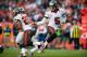 DENVER, CO - DECEMBER 2: Quarterback Josh Freeman #5 hands off to running back Doug Martin #22 of the Tampa Bay Buccaneers during a game against the Denver Broncos at Sports Authority Field Field at Mile High on December 2, 2012 in Denver, Colorado. (Photo by Dustin Bradford/Getty Images)