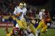 LOS ANGELES, CA - NOVEMBER 24: Theo Riddick #6 of the Notre Dame Fighting Irish rushes past Dion Bailey #18 of the USC Trojans during a 22-13 win at Los Angeles Memorial Coliseum on November 24, 2012 in Los Angeles, California. (Photo by Harry How/Getty Images)