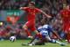 LIVERPOOL, ENGLAND - OCTOBER 20: Mikele Leigertwood of Reading challenges Joe Allen of Liverpool during the Barclays Premier League match between Liverpool and Reading at Anfield on October 20, 2012 in Liverpool, England. (Photo by Clive Brunskill/Getty Images)