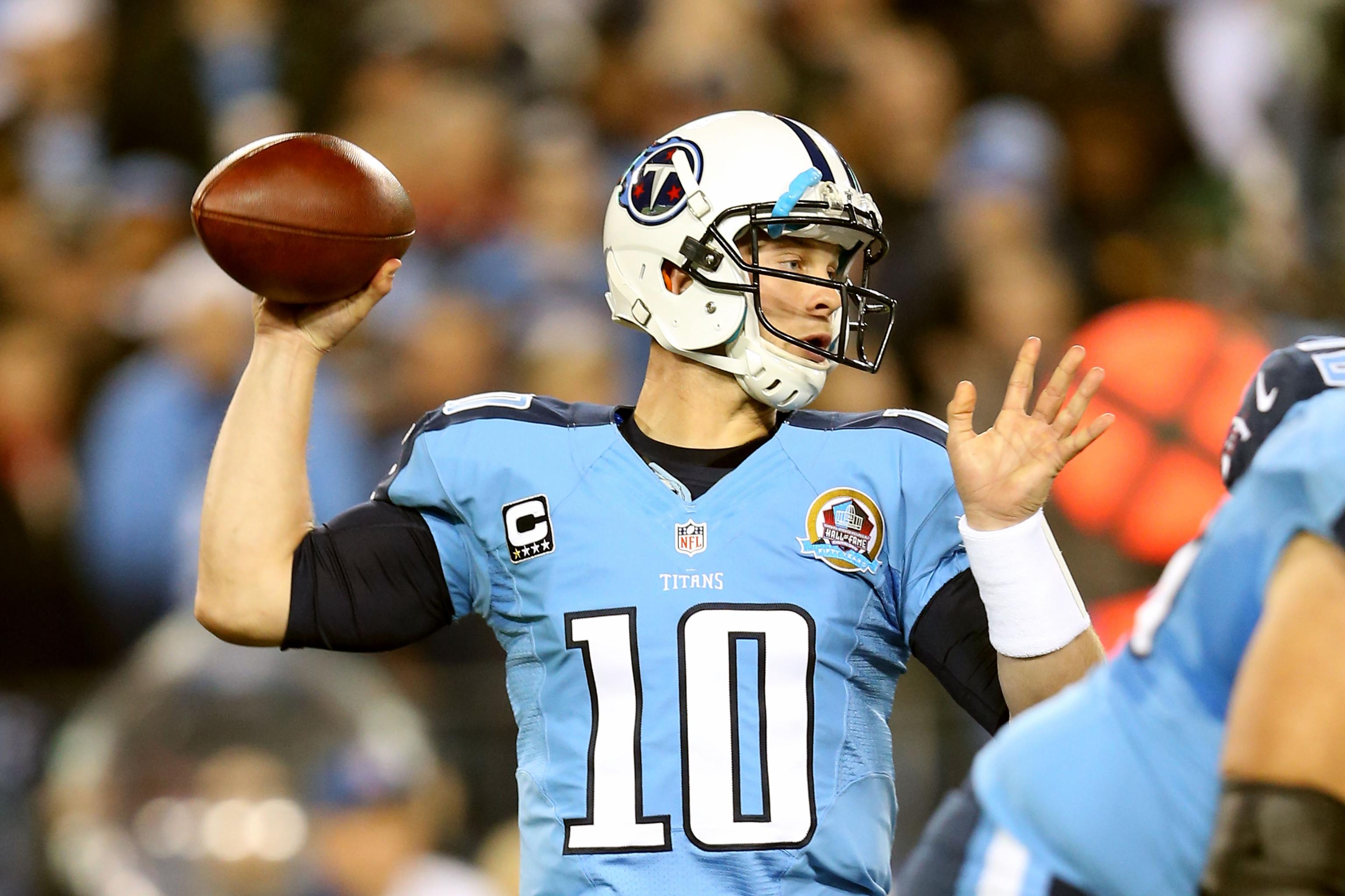 Tennessee Titans quarterback Jake Locker (10) scrambles against