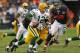 CHICAGO, IL - DECEMBER 16: Aaron Rodgers #12 of the Green Bay Packers rolls out to look for a receiver chased by Cory Wootton #98 of the Chicago Bears at Soldier Field on December 16, 2012 in Chicago, Illinois. The Packers defeated the Bears 21-13. (Photo by Jonathan Daniel/Getty Images)