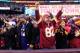 LANDOVER, MD - DECEMBER 09: Washington Redskins fans cheer next to a Baltimore Ravens fan after the Redskins tied the game in the fourth quarter of the Redskins 31-28 overtime win at FedExField on December 9, 2012 in Landover, Maryland. (Photo by Rob Carr/Getty Images)