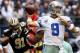 ARLINGTON, TX - DECEMBER 23: Quarterback Tony Romo #9 of the Dallas Cowboys looks for an open receiver under pressure from defensive end Will Smith #91 of the New Orleans Saints at Cowboys Stadium on December 23, 2012 in Arlington, Texas. The New Orleans Saints beat the Dallas Cowboys 34-31 in overtime. (Photo by Tom Pennington/Getty Images)