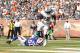 MIAMI GARDENS, FL - DECEMBER 23: Reggie Bush #22 of the Miami Dolphins eludes the tackle by Nick Barnett #50 of the Buffalo Bills to score his second touchdown of the first half on December 23, 2012 at Sun Life Stadium in Miami Gardens, Florida. (Photo by Joel Auerbach/Getty Images)