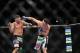 Dec 29, 2012; Las Vegas, NV, USA; Leonard Garcia (left) and Max Holloway (right) exchange strikes during UFC 155 at the MGM Grand Garden Arena. Mandatory Credit: Gary A. Vasquez-USA TODAY Sports
