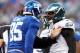 EAST RUTHERFORD, NJ - DECEMBER 30: Brandon Graham #54 of the Philadelphia Eagles and Martellus Bennett #85 of the New York Giants argue after a play in the fourth quarter at MetLife Stadium on December 30, 2012 in East Rutherford, New Jersey. The New York Giants defeated the Philadelphia Eagles 42-7. (Photo by Elsa/Getty Images)
