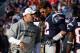 Nov 11, 2012; Foxborough, MA, USA; New England Patriots quarterback Tom Brady (12) talks with offensive coordinator Josh McDaniels on the sideline during the second quarter against the Buffalo Bills at Gillette Stadium. The Patriots defeated the Bills 37-31. Mandatory Credit: David Butler II-USA TODAY Sports