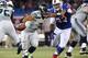 TORONTO, ON - DECEMBER 16: Russell Wilson #3 of the Seattle Seahawks is flushed out of the pocket during an NFL game by Alex Carrington #92 of the Buffalo Bills at Rogers Centre on December 16, 2012 in Toronto, Ontario, Canada. (Photo by Tom Szczerbowski/Getty Images)