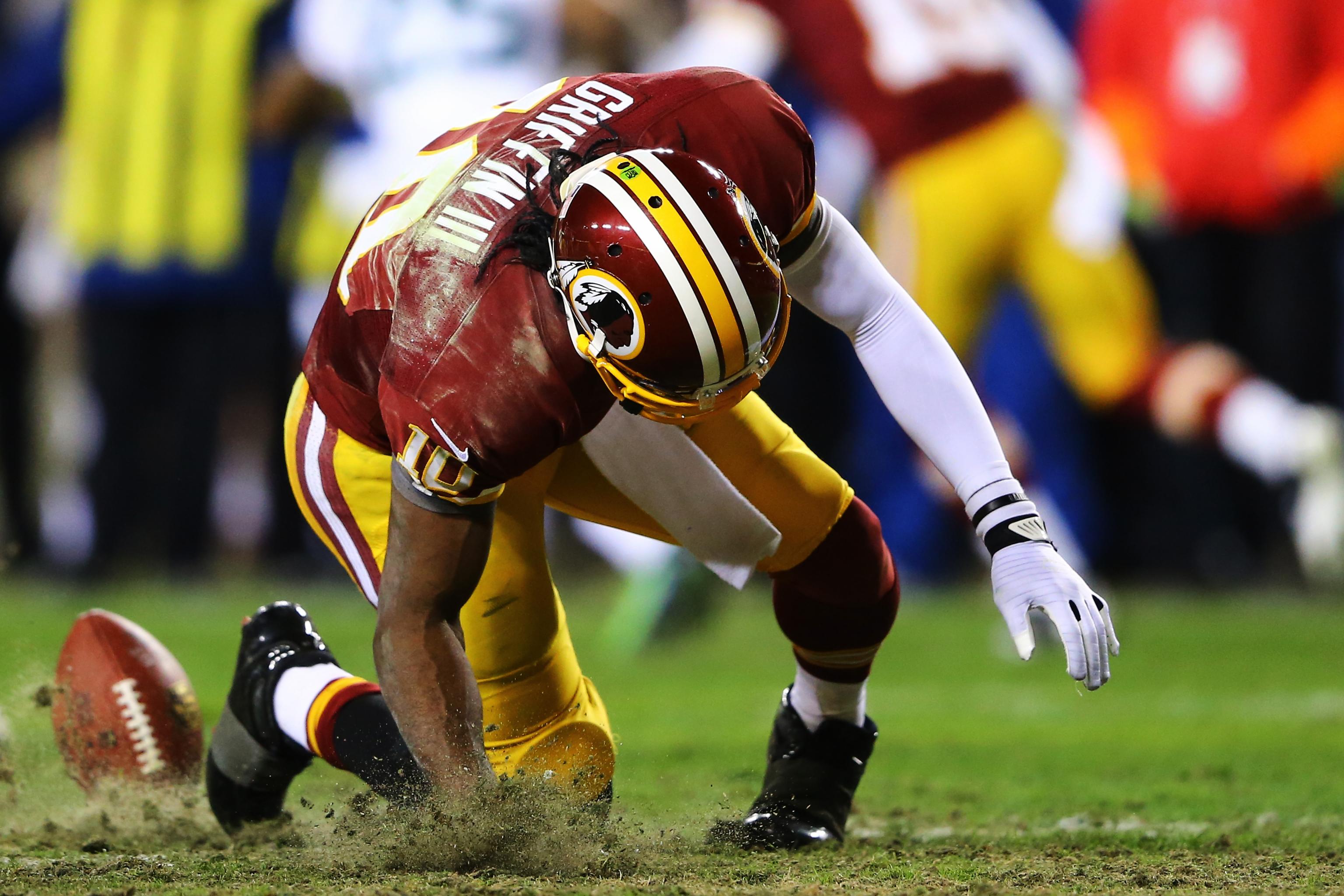 ESPN analyst Robert Griffin III wears a jersey honoring injured