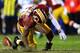 LANDOVER, MD - JANUARY 06: Robert Griffin III #10 of the Washington Redskins is injured as he fumbles a low snap in the fourth quarter against the Seattle Seahawks during the NFC Wild Card Playoff Game at FedExField on January 6, 2013 in Landover, Maryland. (Photo by Al Bello/Getty Images)