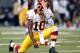 ST LOUIS, MO - SEPTEMBER 16: Quarterback Robert Griffin III #10 of the Washington Redskins 'Tebows' in celebration after throwing a long pass for a touchdown during the game against the St. Louis Rams at Edward Jones Dome on September 16, 2012 in St Louis, Missouri. (Photo by Jamie Squire/Getty Images)