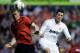 PAMPLONA, SPAIN - MARCH 31: Sergio Fernandez (L) of CA Osasuna heads the ball before Cristiano Ronaldo of Real Madrid CF during the La Liga match between CA Osasuna and Real Madrid CF at Estadio Reyno de Navarra on March 31, 2012 in Pamplona, Spain. (Photo by Denis Doyle/Getty Images)