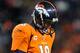DENVER, CO - JANUARY 12: Peyton Manning #18 of the Denver Broncos walks on the field with his head down against the Baltimore Ravens during the AFC Divisional Playoff Game at Sports Authority Field at Mile High on January 12, 2013 in Denver, Colorado. THe Ravens won 38-35 in the second overtime. (Photo by Dustin Bradford/Getty Images)