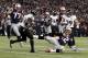 Jan 20, 2013; Foxboro, MA, USA; New England Patriots quarterback Tom Brady (12) slides to avoid a hit from Baltimore Ravens free safety Ed Reed (20) during the second quarter of the AFC championship game at Gillette Stadium. Mandatory Credit: David Butler II-USA TODAY Sports