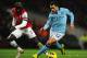 LONDON, ENGLAND - JANUARY 13: Carlos Tevez of Manchester City takes on Bacary Sagna of Arsenal during the Barclays Premier League match between Arsenal and Manchester City at Emirates Stadium on January 13, 2013 in London, England. (Photo by Mike Hewitt/Getty Images)