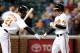 BALTIMORE - SEPTEMBER 13: Brian Roberts #1 of the Baltimore Orioles is congratulated by Nick Markakis #21 after hitting a home run in the first inning against the Toronto Blue Jays at Camden Yards on September 13, 2010 in Baltimore, Maryland. (Photo by Greg Fiume/Getty Images)