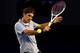 MELBOURNE, AUSTRALIA - JANUARY 25: Roger Federer of Switzerland plays a backhand in his semifinal match against Andy Murray of Great Britain during day twelve of the 2013 Australian Open at Melbourne Park on January 25, 2013 in Melbourne, Australia. (Photo by Julian Finney/Getty Images)