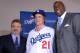Dec 11, 2012; Los Angeles, CA, USA; Zack Greinke (center) poses with Los Angeles Dodgers general manager Ned Colletti (left) and co-owner Magic Johnson at press conference to announce Greinke's signing as a free agent pitcher at Dodger Stadium. Mandatory Credit: Kirby Lee/Image of Sport-USA TODAY Sports