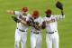 PHOENIX, AZ - JUNE 22: Jason Kubel #13, Chris Young #24 and Justin Upton #10 of the Arizona Diamondbacks celebrate a 6-1 victory against the Chicago Cubs at Chase Field on June 22, 2012 in Phoenix, Arizona. (Photo by Norm Hall/Getty Images)