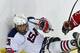Rico Roman behind the net reaching for the puck (Image courtesy of Hockey Canada website)