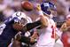 INDIANAPOLIS - SEPTEMBER 19: Dwight Freeney #93 of the Indianapolis Colts hits Eli Manning #10 of the New York Giants causing a fumble during the NFL game at Lucas Oil Stadium on September 19, 2010 in Indianapolis, Indiana. (Photo by Andy Lyons/Getty Images)