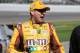 Kyle Busch talks as he walks down pit road to his car. Credit: Dwight Drum