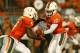 MIAMI GARDENS, FL - OCTOBER 20: Stephen Morris #17 of the Miami Hurricanes hands off to Mike James #5 during a game against the Florida State Seminoles at Sun Life Stadium on October 20, 2012 in Miami Gardens, Florida. (Photo by Mike Ehrmann/Getty Images)