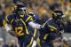 MORGANTOWN, WV - OCTOBER 20: Geno Smith #12 of the West Virginia Mountaineers hands the ball off against the Kansas State Wildcats during the game on October 20, 2012 at Mountaineer Field in Morgantown, West Virginia. (Photo by Justin K. Aller/Getty Images)