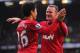 MANCHESTER, ENGLAND - MARCH 02: Shinji Kagawa of Manchester United celebrates scoring to make it 3-0 with team mate and claim a hat-trick with team mate Wayne Rooney during the Barclays Premier League match between Manchester United and Norwich City at Old Trafford on March 2, 2013 in Manchester, England. (Photo by Michael Regan/Getty Images)