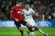 MADRID, SPAIN - FEBRUARY 13: Robin van Persie (L) of Manchester United duels for the ball with Angel Di Maria of Real Madrid during the UEFA Champions League Round of 16 first leg match between Real Madrid and Manchester United at Estadio Santiago Bernabeu on February 13, 2013 in Madrid, Spain. (Photo by Jasper Juinen/Getty Images)