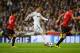 MADRID, SPAIN - FEBRUARY 13: Cristiano Ronaldo of Real Madrid is marshalled by Shinji Kagawa of Manchester United and Rio Ferdinand of Manchester United during the UEFA Champions League Round of 16 first leg match between Real Madrid and Manchester United at Estadio Santiago Bernabeu on February 13, 2013 in Madrid, Spain. (Photo by Mike Hewitt/Getty Images)
