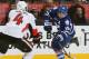 TORONTO, CANADA - FEBRUARY 16: Clarke MacArthur #16 of the Toronto Maple Leafs shoots past Chris Phillips #4 of the Ottawa Senators during NHL action at the Air Canada Centre February 16, 2013 in Toronto, Ontario, Canada. (Photo by Abelimages/Getty Images)