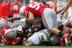 COLUMBUS, OH - SEPTEMBER 8: Storm Johnson #8 of the Central Florida Knights is tackled by John Simon #54 of the Ohio State Buckeyes and C.J. Barnett #4 of the Ohio State Buckeyes during the third quarter on September 8, 2012 at Ohio Stadium in Columbus, Ohio. Ohio defeated Central Florida 31-16. (Photo by Kirk Irwin/Getty Images)