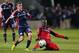 Mar 9, 2013; Chicago, IL, USA; New England Revolution midfielder Donald Smith (33) and Chicago Fire forward Patrick Nyarko (14) battle for the ball during the first half at Toyota Park. Mandatory Credit: Dennis Wierzbicki-USA TODAY Sports