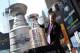 NEW YORK, NY - APRIL 11: A worker positions the Stanley Cup trophy next to a 21 foot replica of the Stanley Cup trophy in Times Square on April 11, 2012 in New York City. To kick off the start of the NHL Stanley Cup playoffs, a 21 foot, 6,600 pound replica of the Stanley Cup trophy was unveiled in Times Square. The replica trophy doubles as a water fountain that New York residents and visitors can drink from. (Photo by Justin Sullivan/Getty Images)