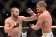 Mar 16, 2013; Montreal, Quebec, CAN; John Makdessi (red gloves) lands a head shot on Daron Cruickshank (blue gloves) during the preliminary round bout at UFC 158 at the Bell Centre. Mandatory Credit: Eric Bolte-USA TODAY Sports