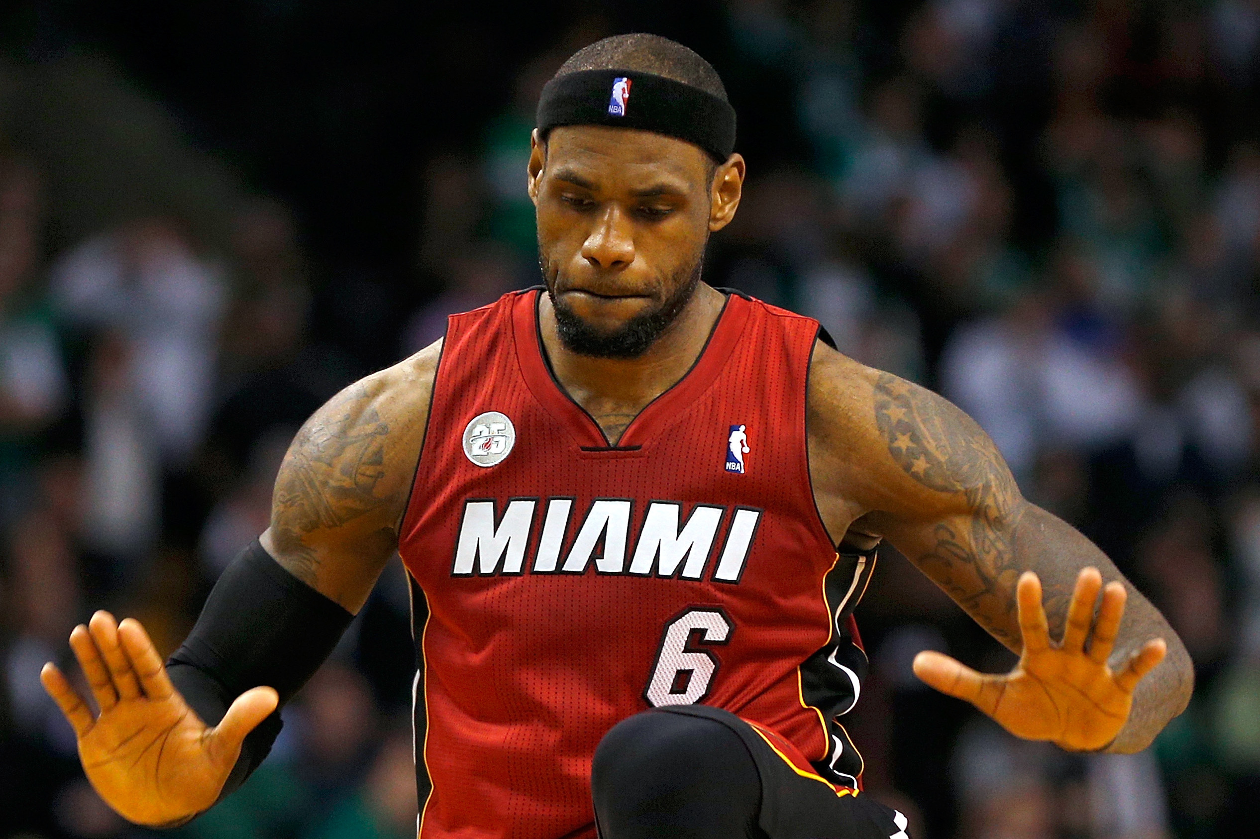 NBA champion Miami Heat's LeBron James, left, motions to the fans