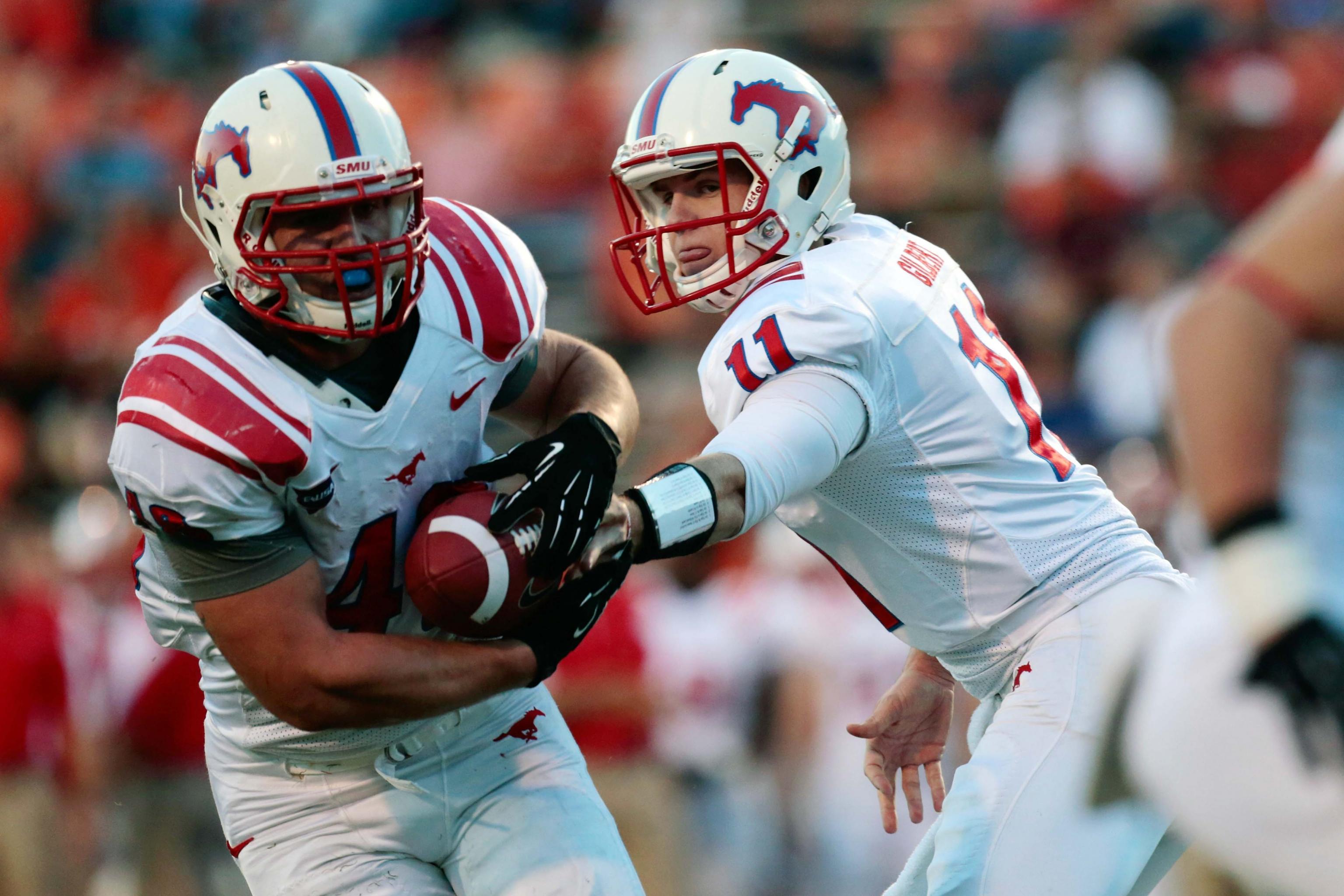 Eric Dickerson of the SMU Mustangs carries the ball during a game