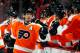 PHILADELPHIA, PA - MARCH 31: Kimmo Timonen #44 of the Philadelphia Flyers is congratulated by teammates after he scored a goal to tie the game late in the third period of an NHL hockey game against the Washington Capitals at Wells Fargo Center on March 31, 2013 in Philadelphia, Pennsylvania. Flyers won 5-4 in overtime. (Photo by Paul Bereswill/Getty Images)